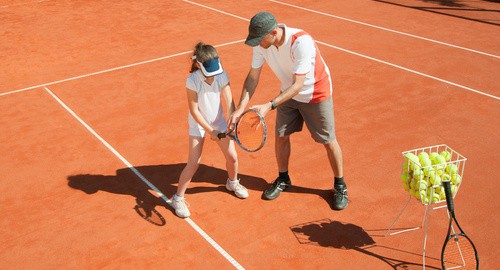 Tennis coach with talented young girl
